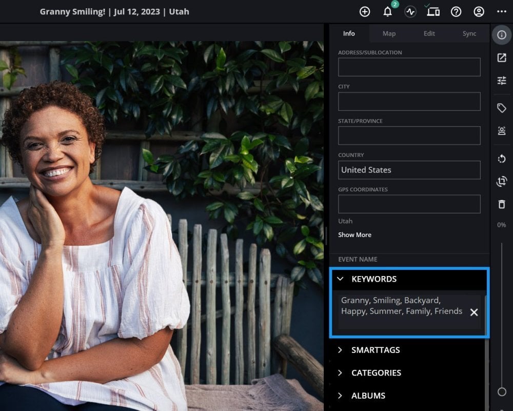 A photo open with the Info panel's Keywords section outlined in blue, showing several keywords and an X to clear them.